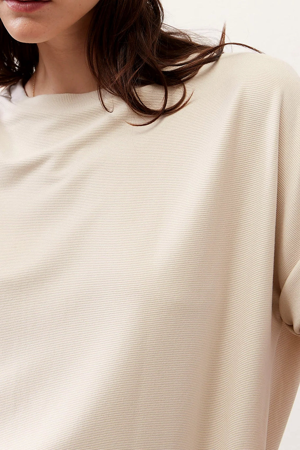 The curved hemline of the top