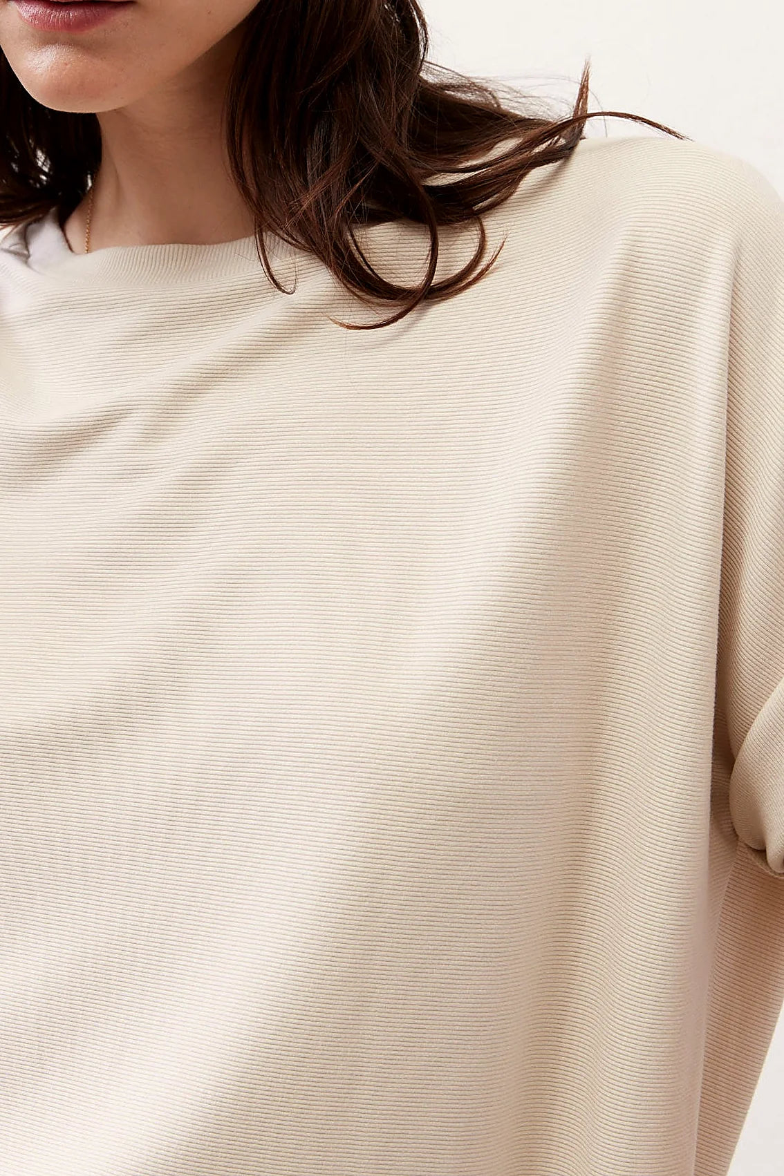 The curved hemline of the top