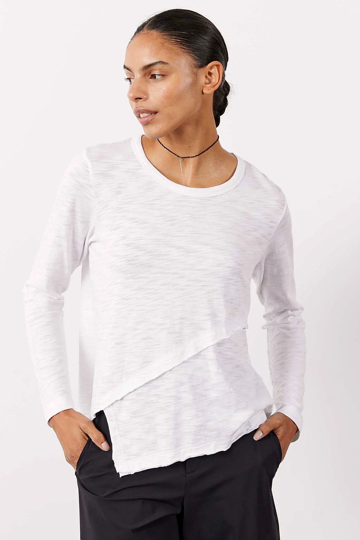 White long sleeve top with an asymmetric hem, front view