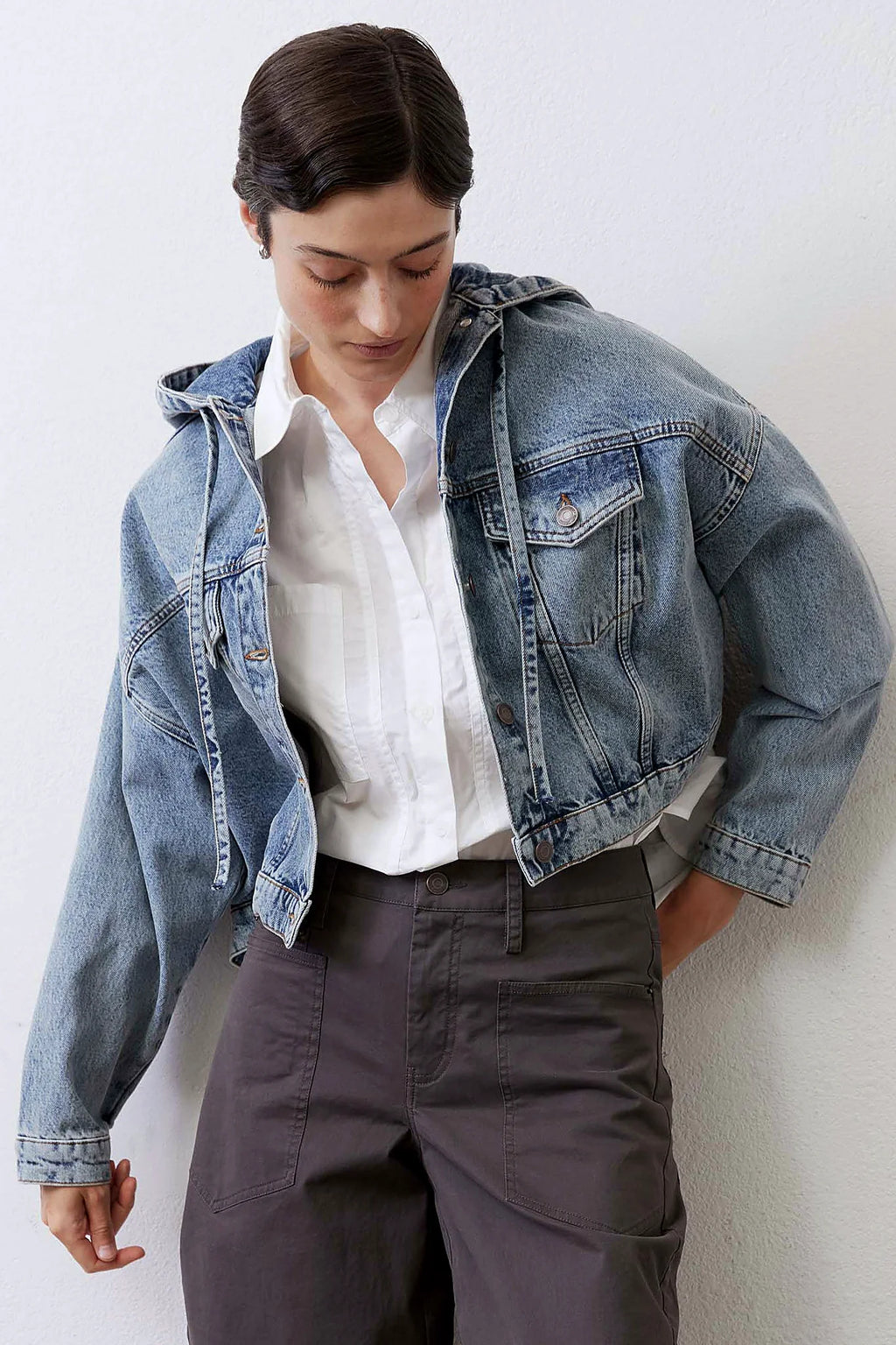 Drawstring hood at the neck of the denim jacket