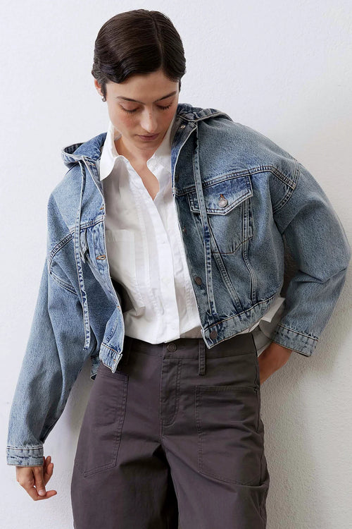 Drawstring hood at the neck of the denim jacket