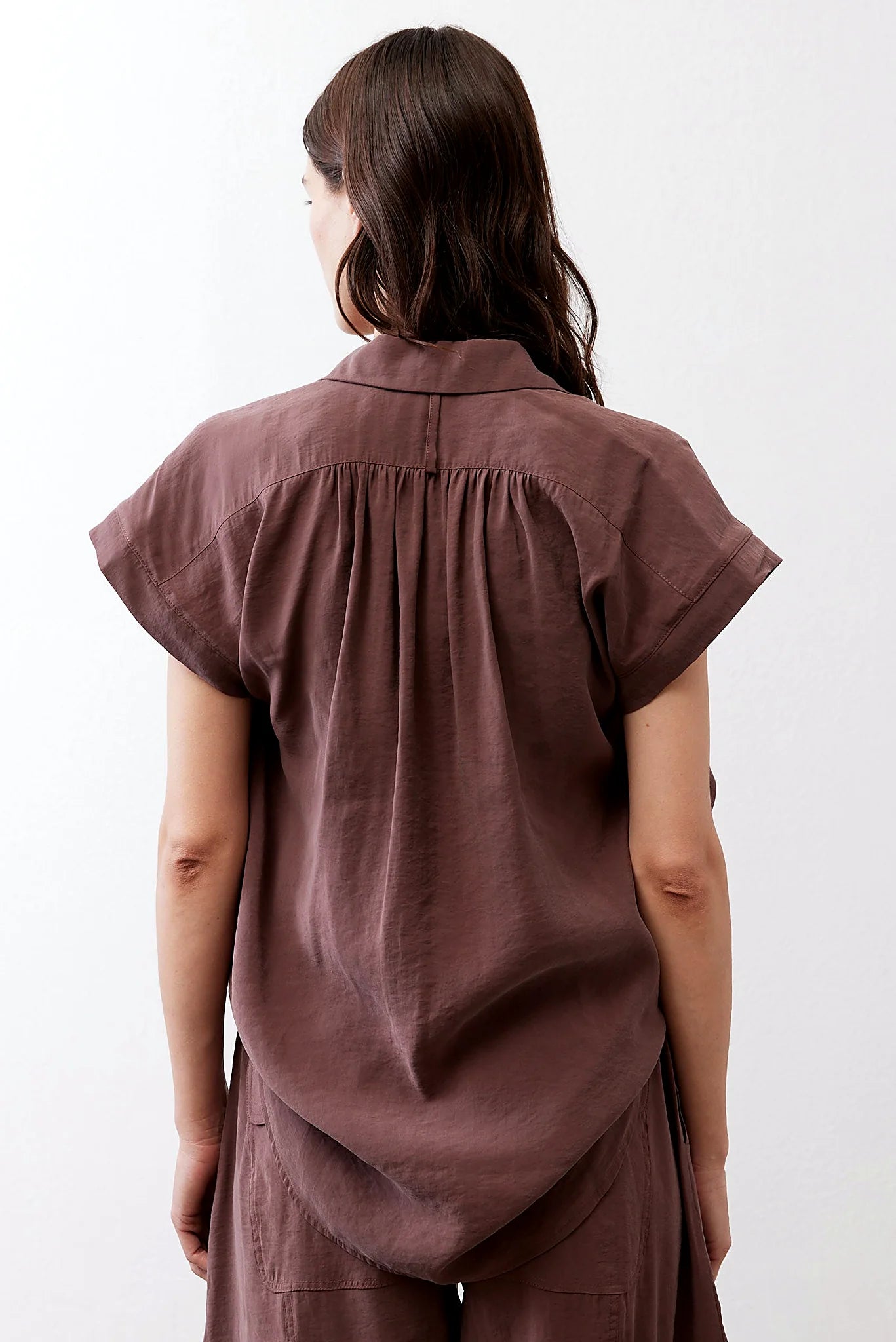 The curved hem and oversized drape