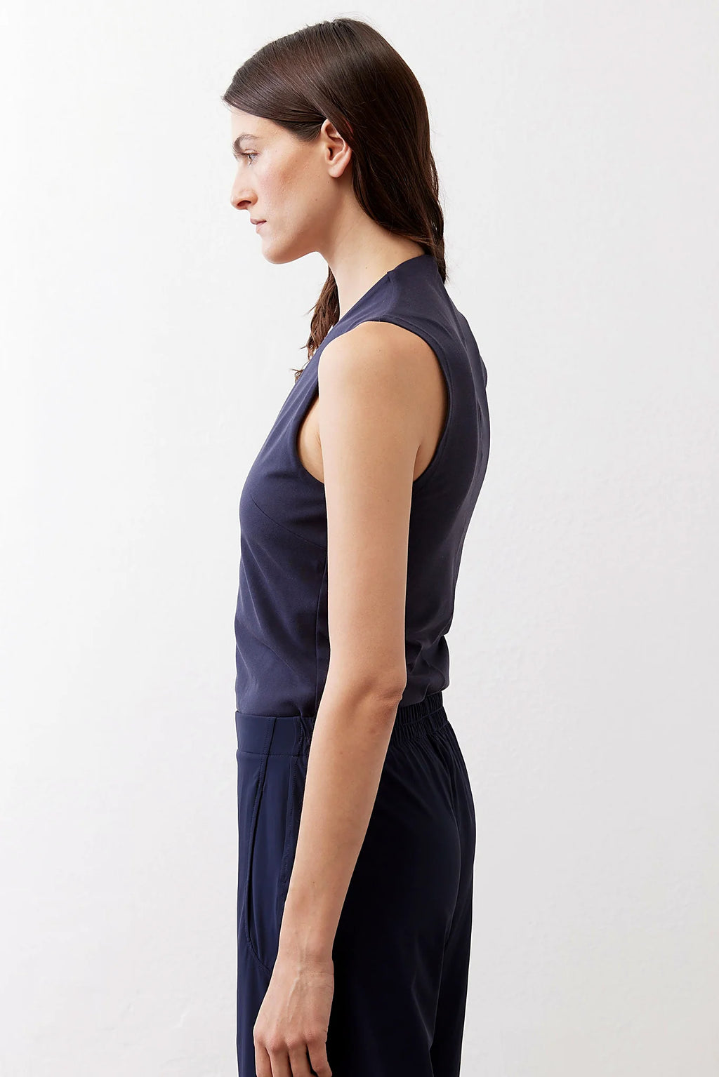 The sleeveless shoulder line of the tank