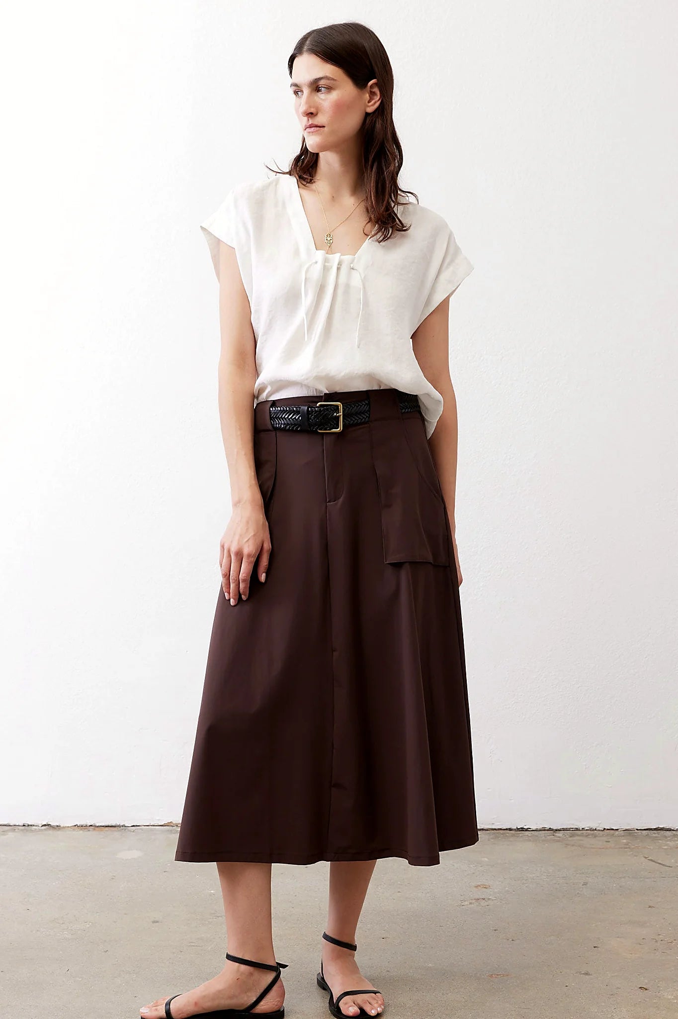 Brown utility skirt with front pockets, front view