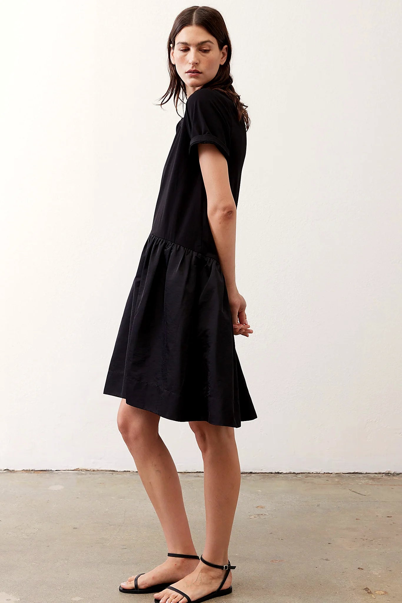 Black short sleeve dress with a ruffle hem, front view